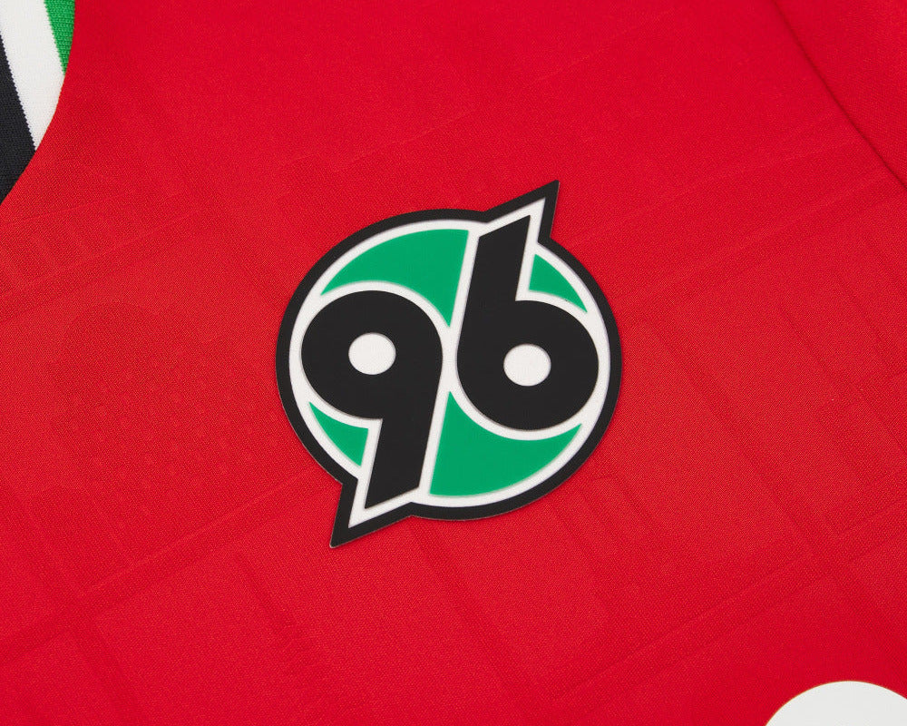 Hannover 96 Kinder Trikot Home 2026  2027 Macron Herren rot geprägte Wahrzeichen Eco Softlock neu mit Etikett. Detailansicht Vereinswappen.